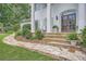 Stone walkway leading to the main entrance with double doors and decorative landscaping at 111 Cherry Hill Dr, Marietta, GA 30067