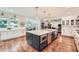 Gourmet kitchen with stainless appliances, an island with seating, and white cabinets at 111 Cherry Hill Dr, Marietta, GA 30067