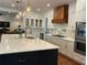 Modern kitchen boasts white cabinets, stainless steel appliances, and a marble backsplash at 111 Cherry Hill Dr, Marietta, GA 30067