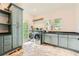 Well-lit laundry room with modern washer and dryer, cabinets and shelving at 111 Cherry Hill Dr, Marietta, GA 30067