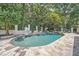 Inviting in-ground pool featuring a stone patio, basketball hoop, slide, and lush landscaping at 111 Cherry Hill Dr, Marietta, GA 30067