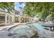 Relaxing backyard with a pool, spa, slide, and covered patio with seating areas at 111 Cherry Hill Dr, Marietta, GA 30067