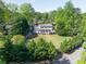 A lovely, well-kept home with a manicured lawn and mature trees at 1647 Grandeus Sw Ln, Stone Mountain, GA 30087