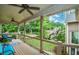 Inviting back porch with ceiling fans, wood floors, and railings overlooking the landscaped backyard at 2001 Mclain Nw Rd, Acworth, GA 30101