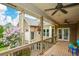 Spacious outdoor back porch area with wooden floors, ceiling fans, and open views of the backyard at 2001 Mclain Nw Rd, Acworth, GA 30101