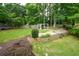 Expansive backyard showcasing a pergola with seating, lush lawn, and mature trees at 2001 Mclain Nw Rd, Acworth, GA 30101