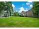 Spacious backyard featuring a pergola, lush lawn, and mature trees at 2001 Mclain Nw Rd, Acworth, GA 30101