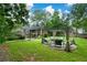 Backyard featuring an open-air patio with comfortable seating under an arbor, surrounded by lush greenery at 2001 Mclain Nw Rd, Acworth, GA 30101