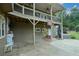 Spacious outdoor patio with fireplace, swing, hot tub, and upper porch above, perfect for entertaining at 2001 Mclain Nw Rd, Acworth, GA 30101