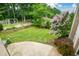 Backyard featuring a stone patio, lush lawn, mature trees, and a pergola with outdoor seating at 2001 Mclain Nw Rd, Acworth, GA 30101