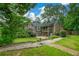 Expansive backyard featuring a lush lawn, mature trees and patio with outdoor seating, ideal for relaxation at 2001 Mclain Nw Rd, Acworth, GA 30101