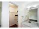 Bathroom with marble vanity, large mirror, and access to open closet with shelving at 2001 Mclain Nw Rd, Acworth, GA 30101
