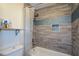 Well-kept bathroom with wood-like tile, shower curtain, and a recessed shampoo nook at 2001 Mclain Nw Rd, Acworth, GA 30101