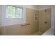 Bathroom featuring a shower and a window for natural light with tile floor at 2001 Mclain Nw Rd, Acworth, GA 30101