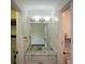 Bathroom with a marble vanity and an open walk-in closet with built in shelving at 2001 Mclain Nw Rd, Acworth, GA 30101