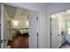 Bright bedroom with wood floors and a partial view of a Bedroom with a crib and attached bath at 2001 Mclain Nw Rd, Acworth, GA 30101