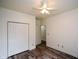 Bedroom featuring a closet, with laminate wood flooring, and a ceiling fan at 2001 Mclain Nw Rd, Acworth, GA 30101