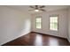 Comfortable bedroom featuring hardwood floors and two windows overlooking the outside at 2001 Mclain Nw Rd, Acworth, GA 30101