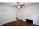 Cozy bedroom with hardwood floors, a ceiling fan, and a large closet at 2001 Mclain Nw Rd, Acworth, GA 30101
