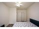 Bright bedroom with hardwood floors, ceiling fan, closet, and white trim at 2001 Mclain Nw Rd, Acworth, GA 30101