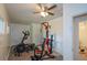 Spacious bonus room featuring gym equipment, ceiling fan, and a double door closet at 2001 Mclain Nw Rd, Acworth, GA 30101