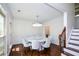 Elegant dining room with hardwood floors and a modern chandelier above a round dining table at 2001 Mclain Nw Rd, Acworth, GA 30101