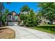 View of home's two car garage and long driveway at 2001 Mclain Nw Rd, Acworth, GA 30101