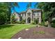 Charming two-story brick home with a well-manicured lawn and lush landscaping at 2001 Mclain Nw Rd, Acworth, GA 30101
