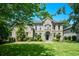 Attractive brick home featuring a lush green lawn, manicured bushes, and mature trees at 2001 Mclain Nw Rd, Acworth, GA 30101
