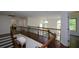Second-floor hallway with decorative iron railings overlooking the kitchen and living area at 2001 Mclain Nw Rd, Acworth, GA 30101