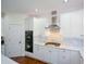 Modern kitchen featuring white cabinets, a marble backsplash, and stainless steel appliances at 2001 Mclain Nw Rd, Acworth, GA 30101