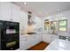Bright kitchen featuring white cabinets, stainless steel appliances, and a marble countertop at 2001 Mclain Nw Rd, Acworth, GA 30101
