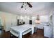 Bright and modern kitchen featuring a marble island, stainless steel appliances, and dark hardwood floors at 2001 Mclain Nw Rd, Acworth, GA 30101