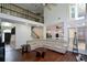 Spacious living room features tall windows, hardwood floors, and access to a modern kitchen at 2001 Mclain Nw Rd, Acworth, GA 30101
