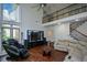 Bright living room with high ceilings, hardwood floors, and staircase access to the second floor at 2001 Mclain Nw Rd, Acworth, GA 30101