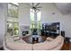 Sunlit living room with large windows, a fireplace, hardwood floors, and comfortable seating at 2001 Mclain Nw Rd, Acworth, GA 30101