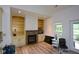Bright living room with a stone fireplace, built-in shelving, and large windows with backyard views at 2001 Mclain Nw Rd, Acworth, GA 30101