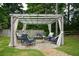 Outdoor pergola with comfortable seating and a fire pit, creating a cozy backyard retreat at 2001 Mclain Nw Rd, Acworth, GA 30101