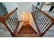 View of wooden staircase with decorative iron railings, leading to the lower level at 2001 Mclain Nw Rd, Acworth, GA 30101