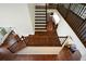 Elegant staircase with hardwood steps and decorative iron railings and access to the kitchen at 2001 Mclain Nw Rd, Acworth, GA 30101