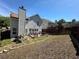 View of the home's fenced backyard with a deck and mature trees at 3889 Sidney Lanier Blvd, Duluth, GA 30096
