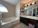 Bright bathroom with soaking tub, and spacious vanity offers a relaxing at-home spa experience at 3889 Sidney Lanier Blvd, Duluth, GA 30096