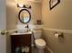 Cozy half bathroom with a modern vanity, round mirror, and stylish fixtures at 3889 Sidney Lanier Blvd, Duluth, GA 30096