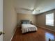 Bright bedroom with wood floor, ceiling fan, and a large window overlooking the side yard at 3889 Sidney Lanier Blvd, Duluth, GA 30096