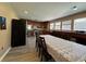 Eat-in kitchen features wood cabinets, stainless appliances and dining area near sunny windows at 3889 Sidney Lanier Blvd, Duluth, GA 30096