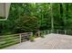 Backyard wooden deck features white railings and wooded views at 4766 Jamerson Forest Cir, Marietta, GA 30066