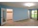 Spacious carpeted bedroom with ensuite closet, light blue walls, and bright window at 4766 Jamerson Forest Cir, Marietta, GA 30066