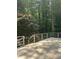 View of the wood deck and backyard with privacy provided by the surrounding trees at 4766 Jamerson Forest Cir, Marietta, GA 30066