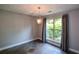 Dining room features a decorative chandelier, window views, and multi-tone tile floors at 4766 Jamerson Forest Cir, Marietta, GA 30066
