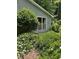 A close up view of the home showcasing the manicured garden and large window for natural light at 4766 Jamerson Forest Cir, Marietta, GA 30066